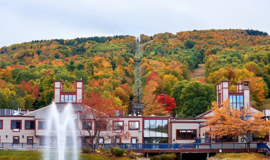 Autumn hillside above a lodge with a fountain